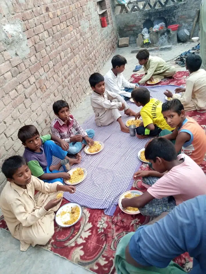 Mahmood feeding poor children